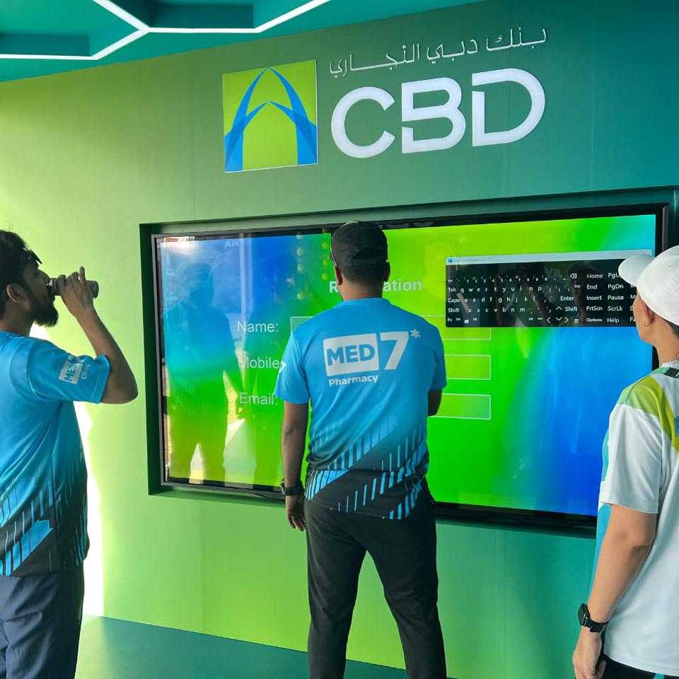 Interactive multi-level touch screen game rental at Dubai 30x30 event, showing guests engaged in a gamified fitness and financial literacy challenge.